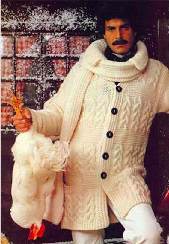 Man in matchy-matching knit outfit holding a chicken upside down