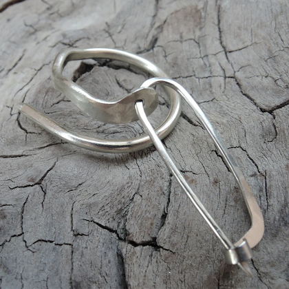 a silver spiral ring that can be used as a cable needle and a safety pin stitch holder, designed by Material Morfosi